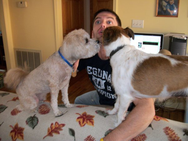Letting two dogs like your face at the same time is going to piss your wife off.